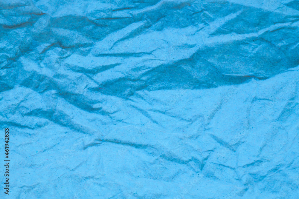 Fototapeta premium Blue crumpled paper background.