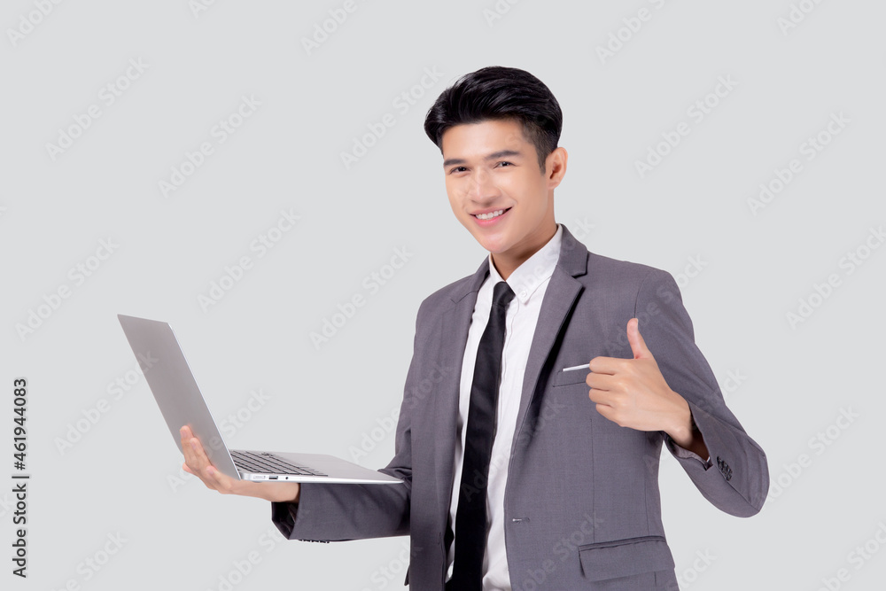 Young asian business man standing work on laptop computer to internet online isolated on white background, businessman confident and notebook, freelance with success, marketing and communication. Young asian business man standing work on laptop computer to internet online isolated on white background, businessman confident and notebook, freelance with success, marketing and communication.