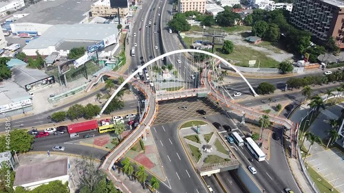 vista superior de drone avazando por la calle principal maximo gomez de la cuidad de santo domingo, transito ligero con autos en la espera de semaforo photo