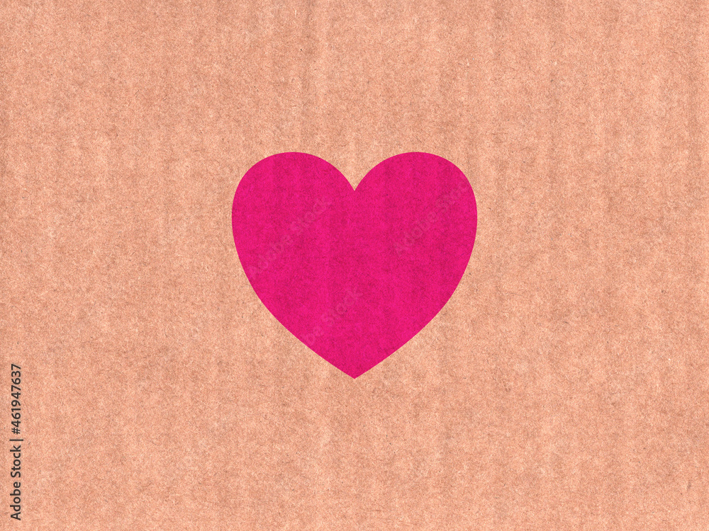 Pink heart icon on cardboard texture