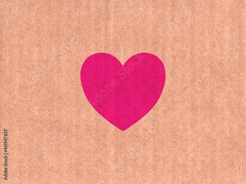 Pink heart icon on cardboard texture