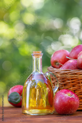 apple vinegar or cider in glass bottle outdoors