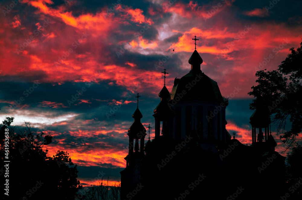 Religious church building silhouetted. Red majestic sky
