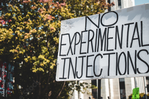 View of sign No Experimental Injections during the rally against the BC Vaccine Card in front of Vancouver City Hall