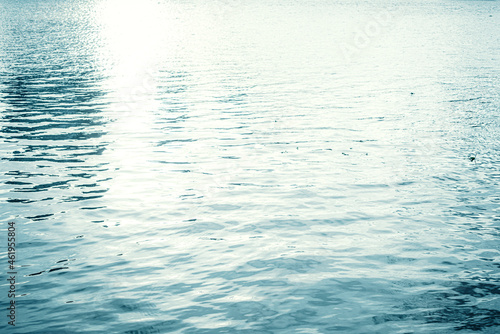 Water surface with ripples and sunlight reflections