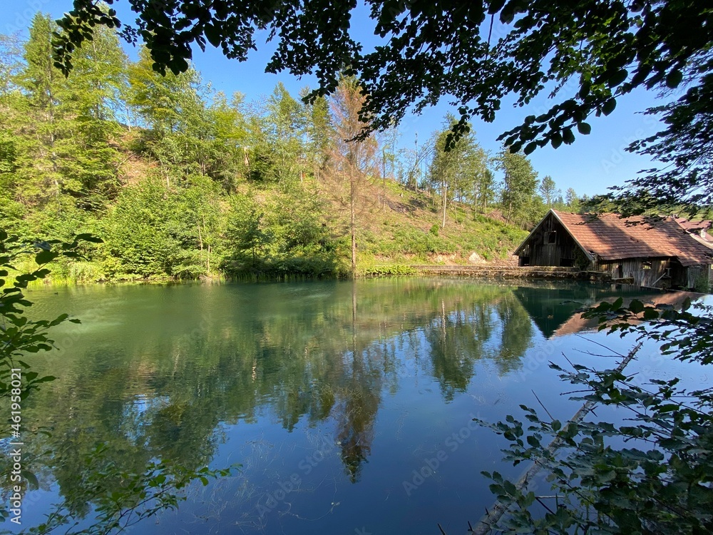Fototapeta premium Remains of an old sawmill on the small dam of Čogrljevo Lake in the mountain hamlet of Tići - Gorski kotar, Croatia (Ostaci stare pilane na maloj brani Čogrljevog jezera u goranskom zaselku Tići)