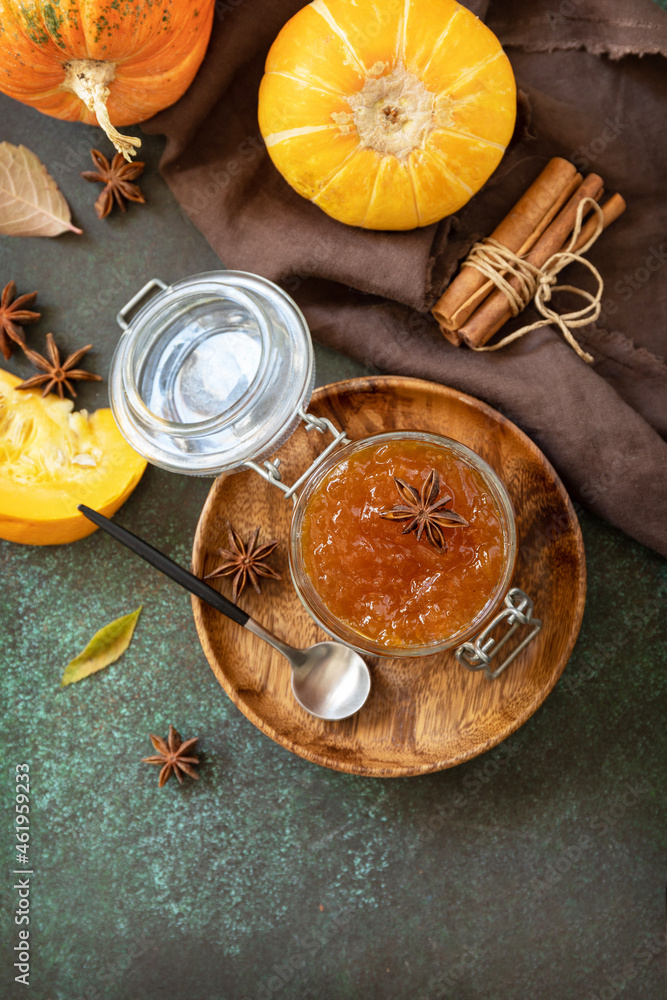 Homemade preserved, delicious sweet spicy sauce. Pumpkin confiture, jam, chutney sauce with spices on stone table. Top view flat lay. Copy space. Homemade preserved, delicious sweet spicy sauce. Pumpkin confiture, jam, chutney sauce with spices on stone table. Top view flat lay. Copy space.