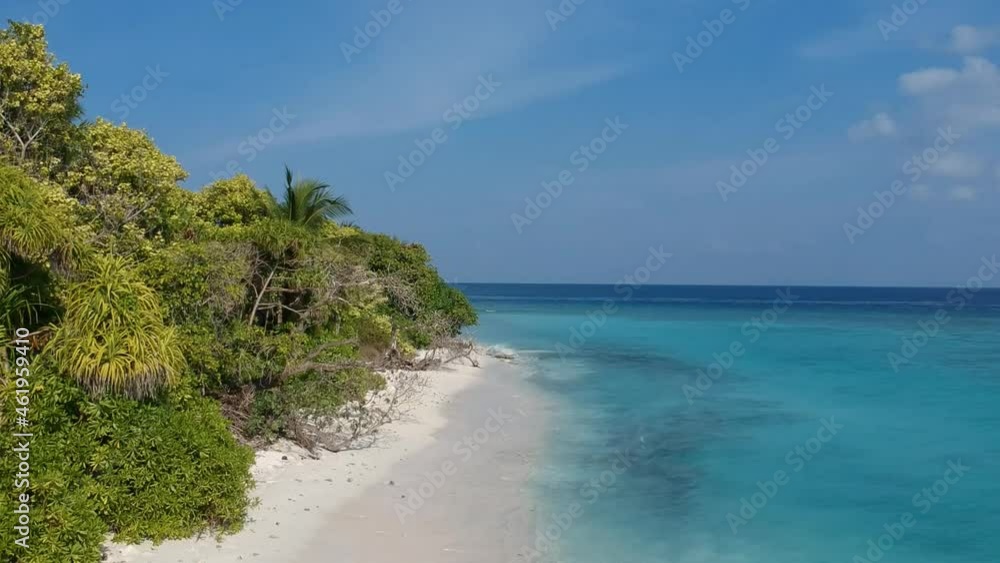 Beautiful beach turquoise ocean water and Green palm trees on the beach in Maldives Beautiful beach turquoise ocean water and Green palm trees on the beach in Maldives
