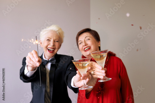 Two beautiful stylish mature senior women celebrating new year. Fun, party, style, celebration concept 