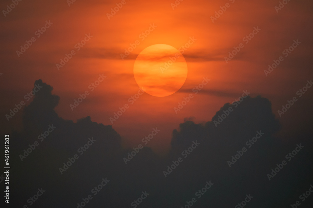 Sun disk through the clouds at sunset above the horizon. Sun disk through the clouds at sunset above the horizon.