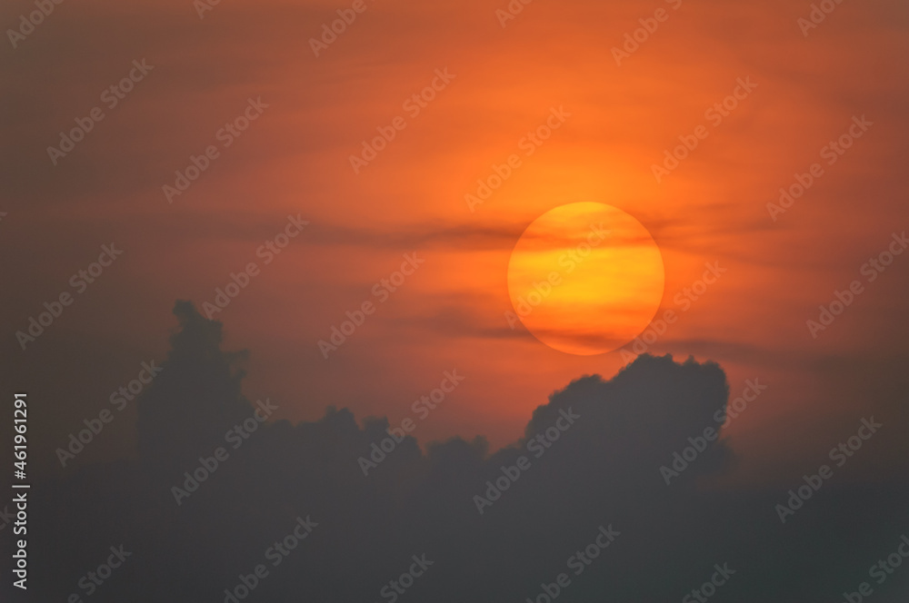 Sun disk through the clouds at sunset above the horizon. Sun disk through the clouds at sunset above the horizon.