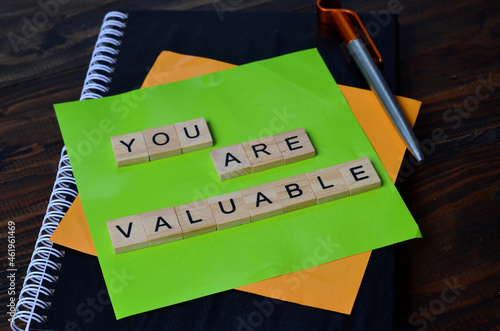 you are valuable, text words typography on wooden background, life and business motivational inspirational concept photo