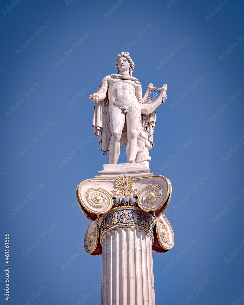 Apollo the ancient Greek god of poetry and music under blue sky with space for your text, Athens Greece Apollo the ancient Greek god of poetry and music under blue sky with space for your text, Athens Greece
