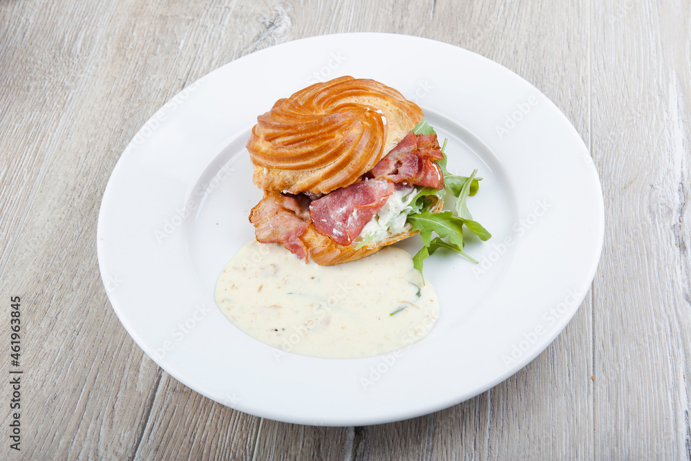 puff with egg benedic, bacon and cheese sauce puff with egg benedic, bacon and cheese sauce