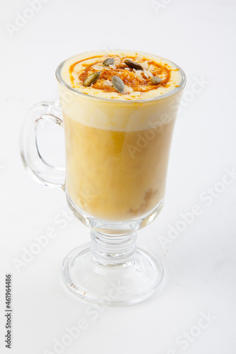hot pumpkin latte with pumpkin seeds in a transparent glass