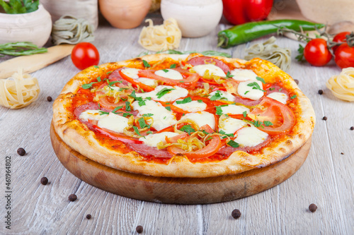 italian pizza on a wooden background with decoration around