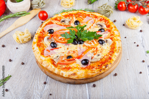 italian pizza on a wooden background with decoration around