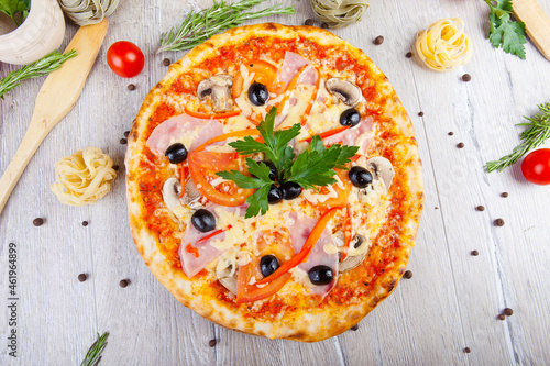 italian pizza on a wooden background with decoration around