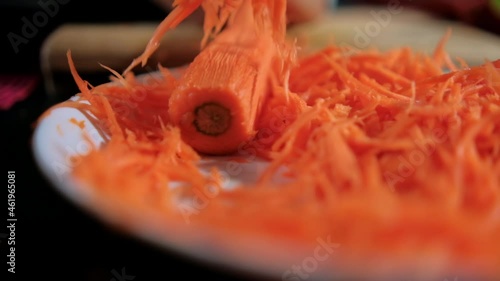 Wallpaper Mural Hands peeling thin carrot with julienne peeler above white plate Torontodigital.ca