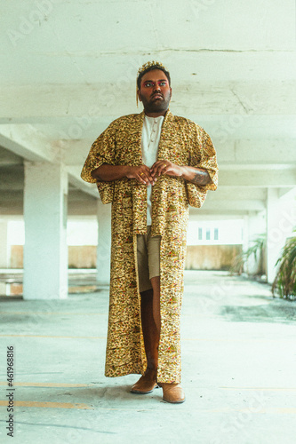 portrait of gay dark skinned indian man in abandoned building photo