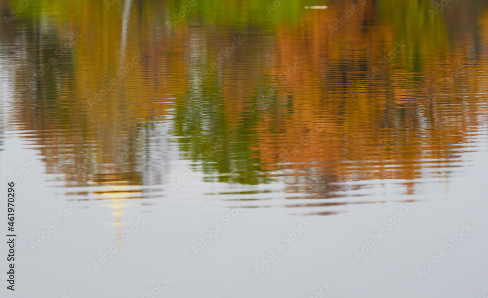 Autumn color is reflected in the still water of the lake Autumn color is reflected in the still water of the lake
