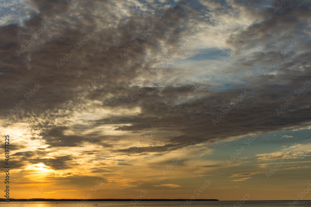 Evening sky with dramatic clouds over the sea. Dramatic sunset over the sea.