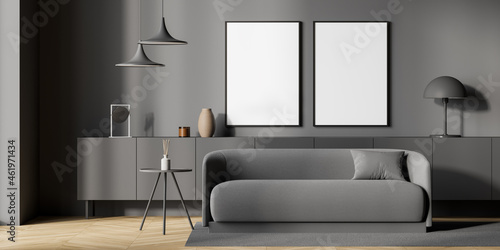 Two empty canvases with sofa in minimalist grey living room