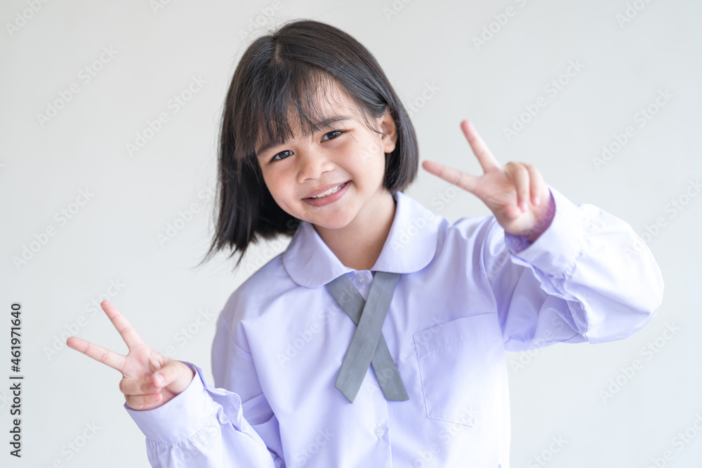 Portrait of a cheerful child student isolated on white background smiles and looks at the camera. Back to School Concept Stock Photo Portrait of a cheerful child student isolated on white background smiles and looks at the camera. Back to School Concept Stock Photo