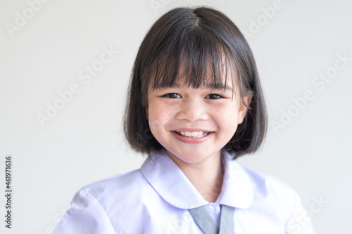 Portrait of a cheerful child student isolated on white background smiles and looks at the camera. Back to School Concept Stock Photo
