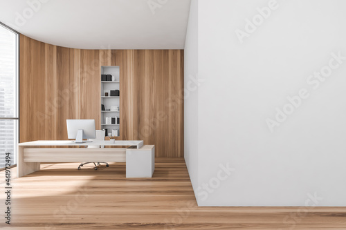 Wooden consulting room interior with table and computer near window. Mockup photo