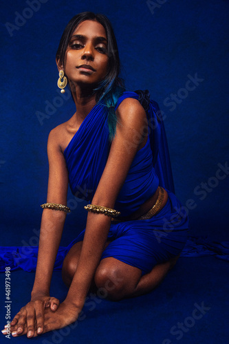 Canvas Print portrait of dark skinned Indian woman from Malaysia against a dark blue backgrou