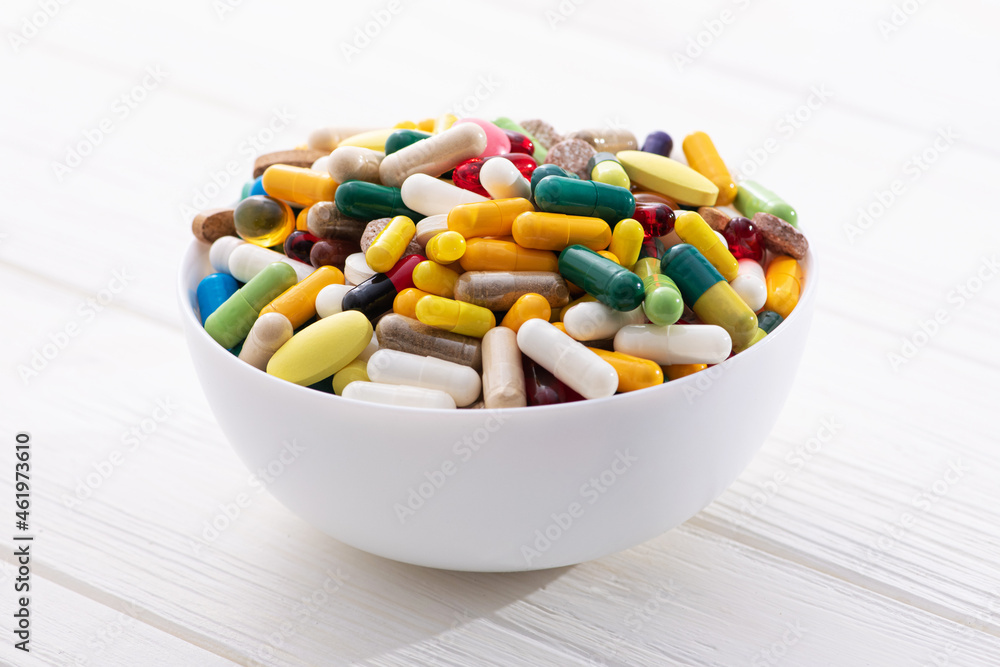 Plate full of colored pills and medical capsule Plate full of colored pills and medical capsule