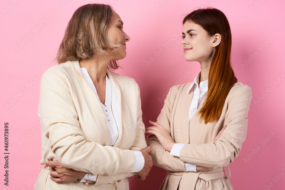 Mom and daughter hug together family caring pink background Mom and daughter hug together family caring pink background