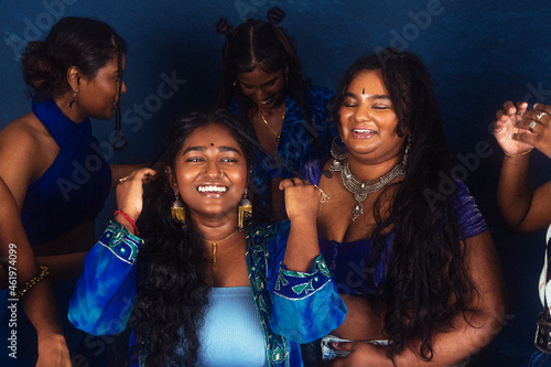 Canvas Print group portraits of dark skinned Indian women from Malaysia against a dark blue b