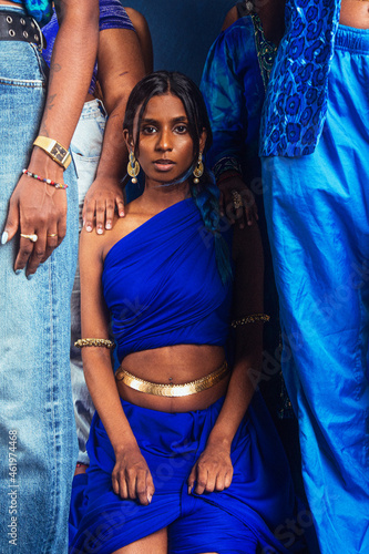 group portraits of dark skinned Indian women from Malaysia against a dark blue background