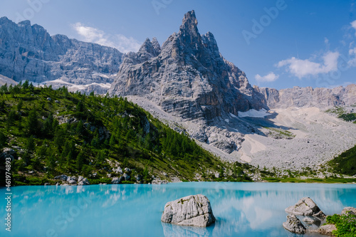 Lake Sorapis Italian Dolomites, Morning with clear sky on Lago di Sorapis in Italian Dolomites, lake with unique turquoise color water in Belluno province in Nothern Italy.  photo