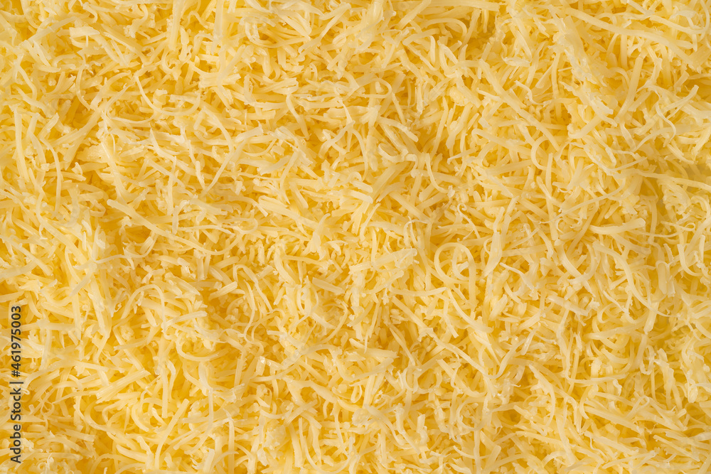 Grated cheese background texture. yellow shredded cheese. Close up top view. Grated cheese background texture. yellow shredded cheese. Close up top view.