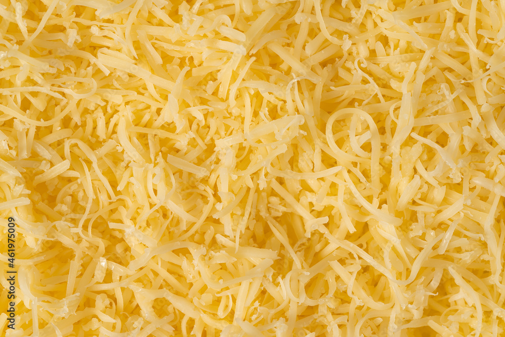 Grated cheese background texture. yellow shredded cheese. Close up top view. Grated cheese background texture. yellow shredded cheese. Close up top view.