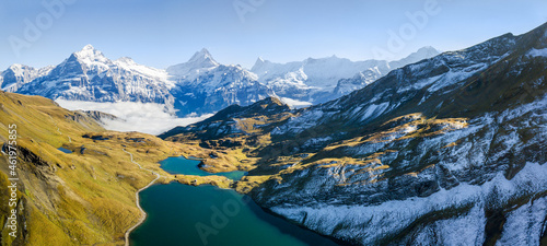 Aerial panorama over Bachalpsee on the First peak in Grindelwald with the famous Alps summit Wetterhorn, Schreckhorn and Eiger.