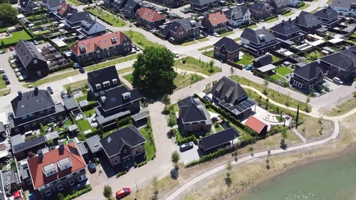 Aerial bird view of nearly finished construction project of new real estate property showing houses next to each other with some infrastructure still needs finishing solving Dutch housing shortage 4k photo