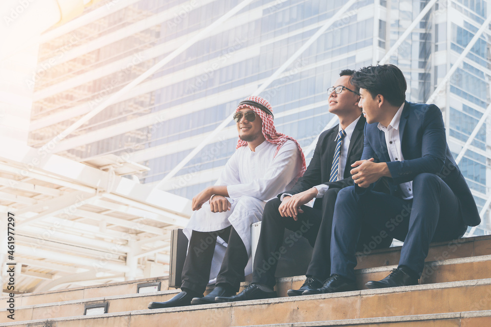 Young businessteam and business partners sitting on stairs for consulting in his business. Young businessteam and business partners sitting on stairs for consulting in his business.