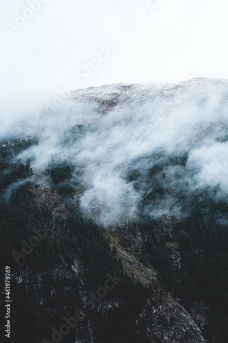 The slopes of the mountains in the fog