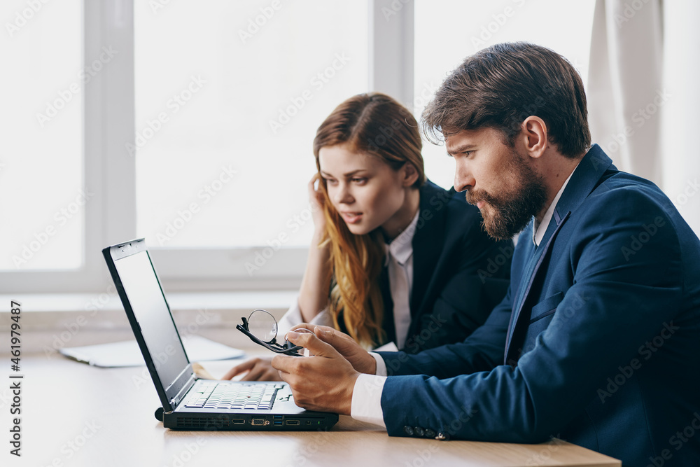 managers sitting in front of a laptop teamwork professionals managers sitting in front of a laptop teamwork professionals