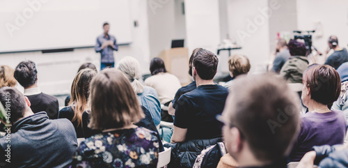 Man giving presentation in lecture hall at university.