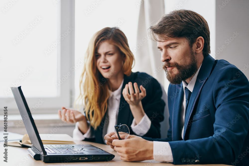 Fototapeta premium managers in the office in front of a laptop career work officials