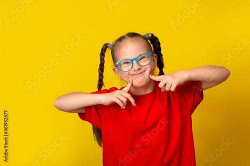 Happy girl with Down syndrome having fun and laughing in the studio photo
