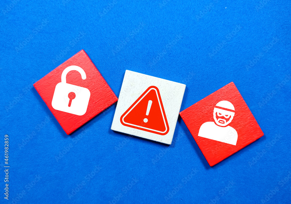 Colored wooden board with cyber robber icons, caution and unlock. safety and security Colored wooden board with cyber robber icons, caution and unlock. safety and security
