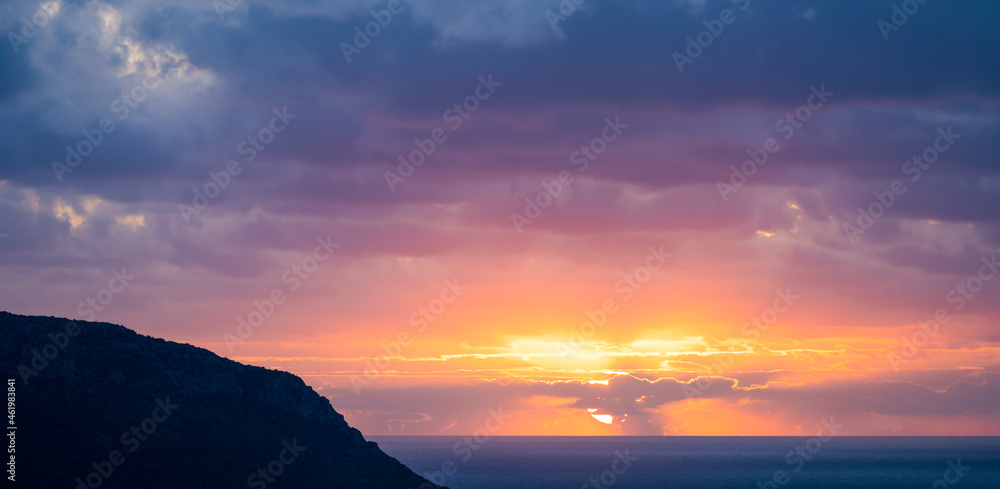 Fototapeta premium Natural background, stunning view of a dramatic, cloudy sunrise. Romantic sky, copy space, sky replacement, Sardinia, Italy.