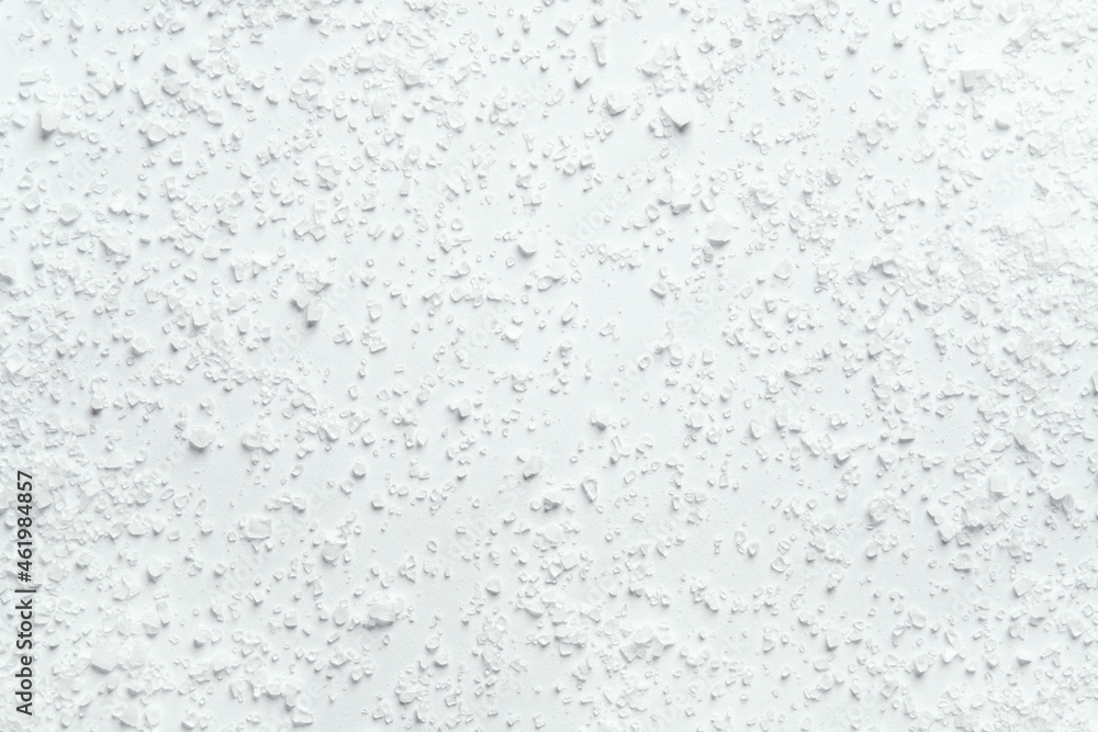 Coarse kitchen salt crystals scattered on a white background Coarse kitchen salt crystals scattered on a white background