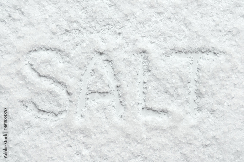 The word Salt on a background of scattered salt crystals